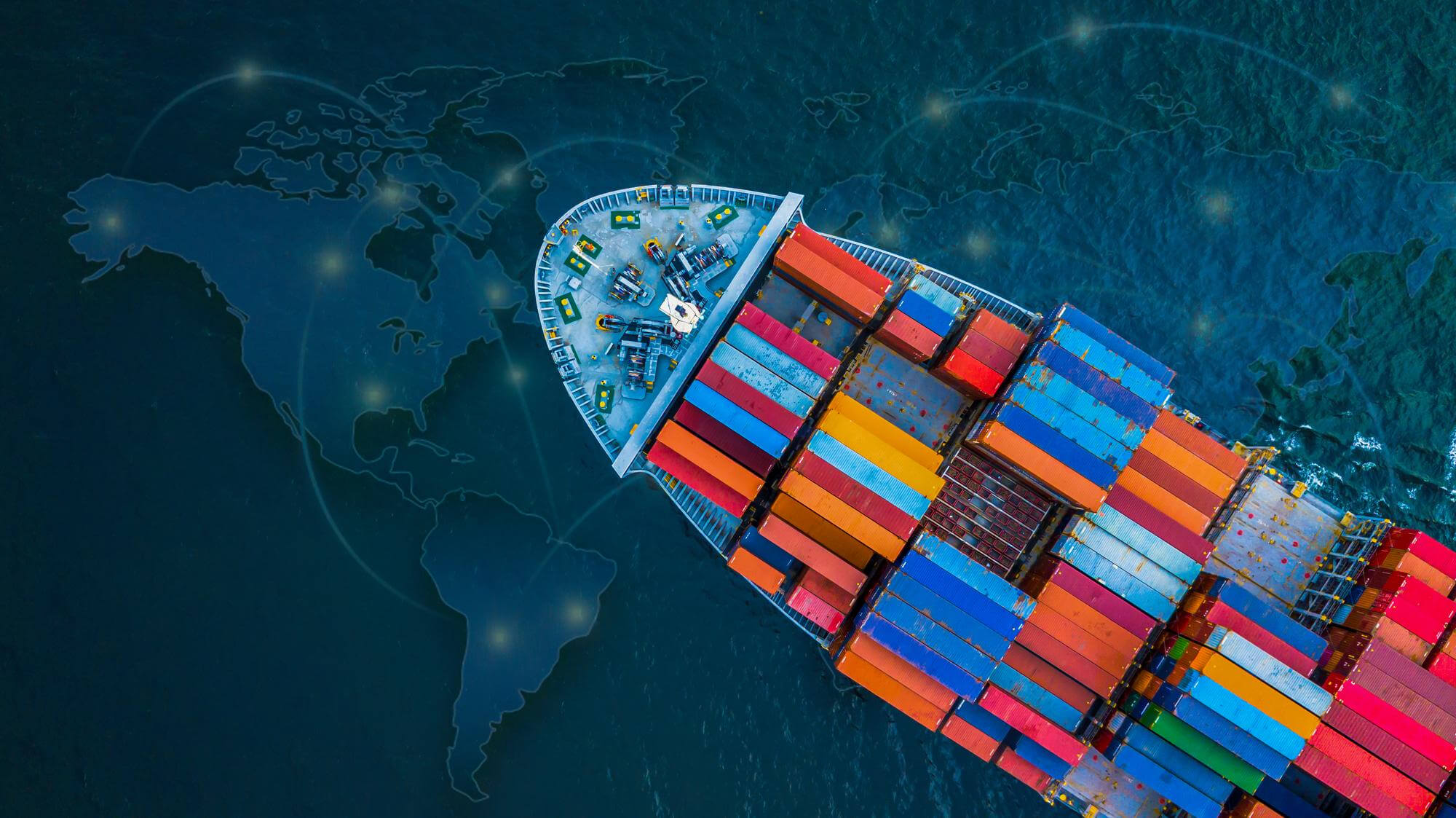An aerial, top-down view of a large cargo ship loaded with colorful containers, overlaid with a digital world map and glowing connection lines.